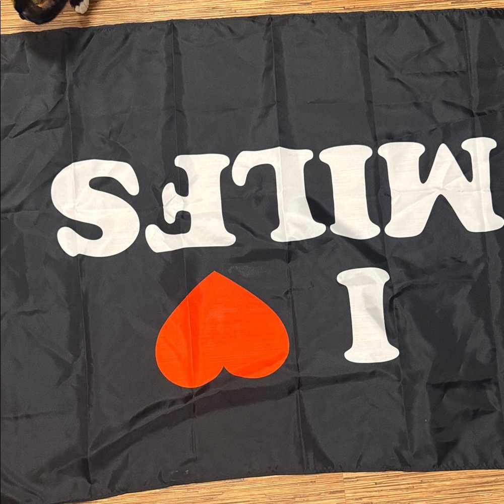 Black Flag with White Text and Red Heart